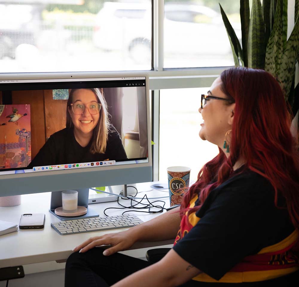 Creative Director Leticia on the computer facetiming with our Cultural Designer Lauren.