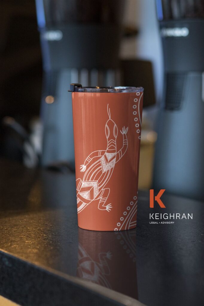 A travel mug with an Aboriginal artwork of a goanna.