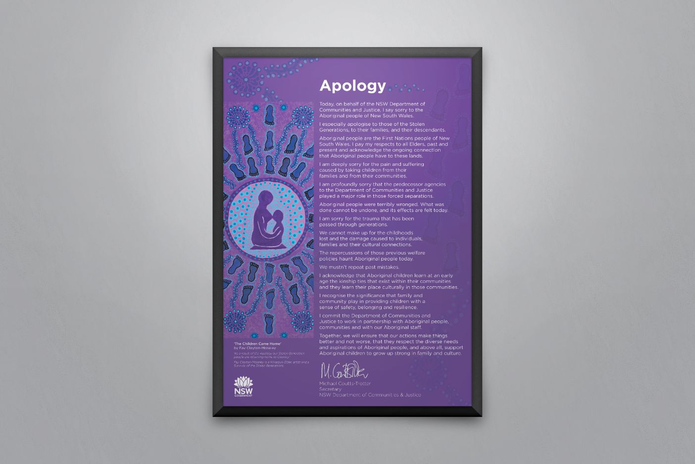 A large framed artwork hanging on the wall. The artwork is purple with two people in the middle and the caption 'Apology'.