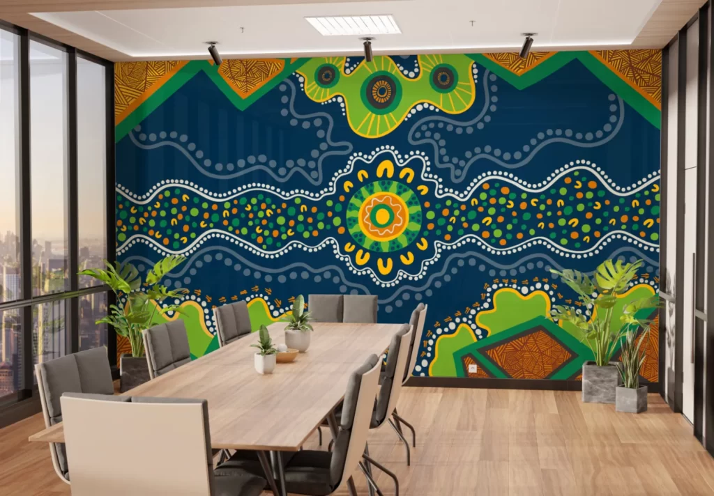 An office space with a desk in the middle and a large Aboriginal artwork across the wall.